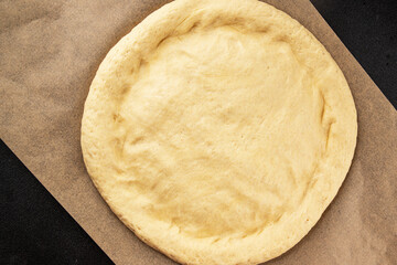 Raw pizza dough making pizza base tasty snack fresh delicious gourmet food background on the table rustic top view copy space