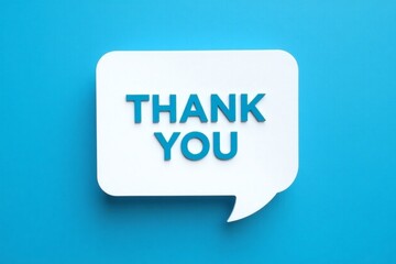Speech bubble with the words thank you in front of a blue colored wall 
