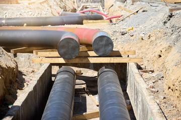 Close-up of district heating pipes at an urban construction site, ready for installation. Ideal...
