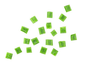 Green bell pepper pieces isolated on a white background, top view. Green paprika cubes.