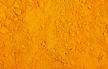 Curcuma spice powder as background, top view. Turmeric fragrant.