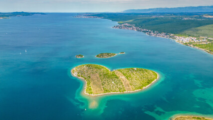 Aerial view of Galešnjak, the famous heart-shaped island located near Sveti Filip i Jakov in the Adriatic Sea, Croatia. Known as the “Island of Love,” it is one of the world’s most romantic natural © Viktor