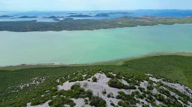 Panoramic view from Vidikovac Kamenjak, the highest point above Vransko Lake Nature Park in Croatia. The viewpoint offers breathtaking views of the Adriatic Sea, surrounding islands, and Dalmatia