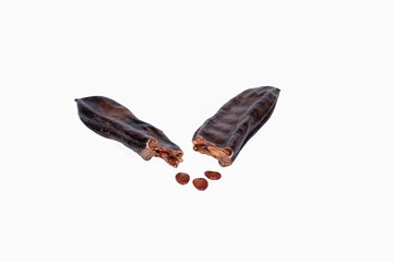 Carob pods with seeds isolated on white background
