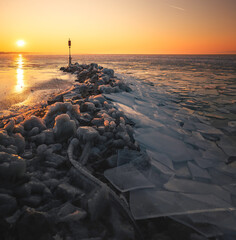 Winter ice shards on frozen Lake Balaton at sunset, Hungary