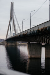 A striking perspective of a cable-stayed bridge over a calm river, showcasing urban infrastructure and architectural design