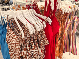 Summer fashion trends displayed in a vibrant store setting with colorful dresses