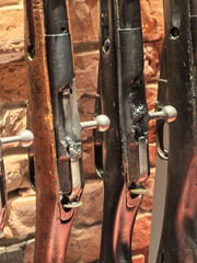 Vintage rifles on a rustic wall highlight history and craftsmanship