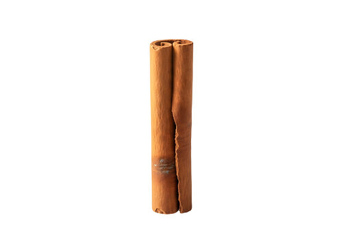 A single cinnamon stick stands out against a stark black background, showcasing its warm, earthy tones and textured surface.