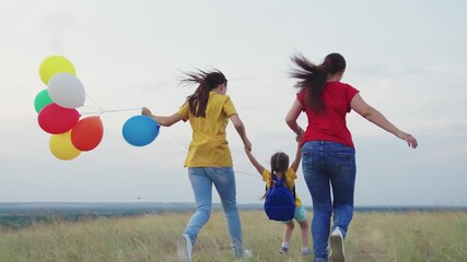 running family park. happy mother child kid run teamwork. colorful air balloons fly wind. mom girl daughter travel nature. inflated helium balloons festive mood. holiday happy family. children dream.