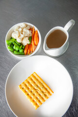 Baked polenta with vegetable broth and side of steamed vegetables
