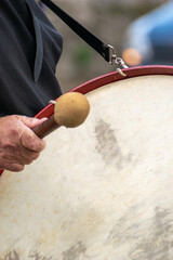 A Man's Hand Playing a Traditional Bass Drum. Concept The rhythm of folk music.