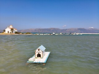 Floating Goose House by the Greek Sea with Orthodox Church