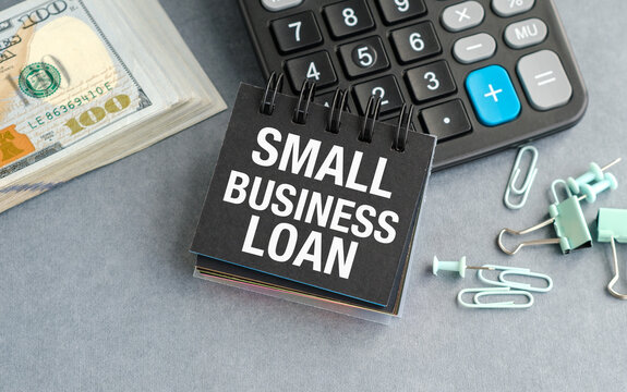 A small business loan is written on a black notebook