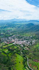 Magical neighborhood of Bellavista next to the Tepic highway, and Sanganguey volcano in the background, Mexico
