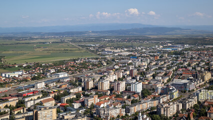 Naklejka premium an elevated view of debrecen, hungary on a sunny day. the cityscape features apartment blocks and residential houses with a railway line