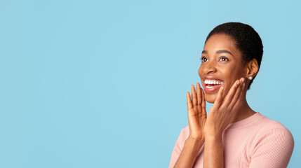 Portrait Of Happy Excited Black Woman Touching Face With Amazement And Looking Away, Surprised...
