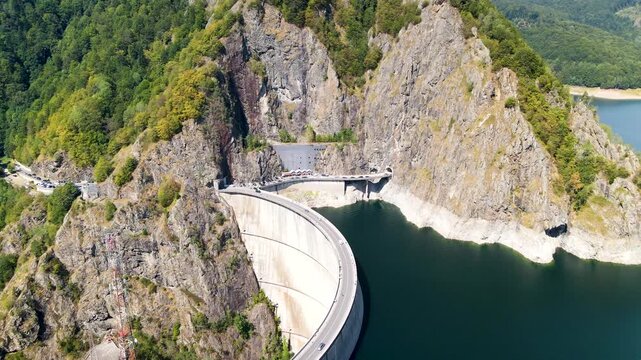 Barajul Vidraru Dam on Transfagarasan Highway, Romania. Aerial panoramic drone view from above, top view from drone . Summer holidays in Europe. The most beautiful road in the world, amazing scenery v