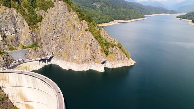 Barajul Vidraru Dam on Transfagarasan Highway, Romania. Aerial panoramic drone view from above, top view from drone . Summer holidays in Europe. The most beautiful road in the world, amazing scenery v