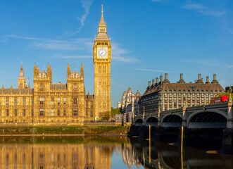 Houses of parliament with Big Ben tower and Westminster bridge reflected in Thames river, London, UK