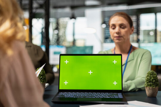 Team of ambitious shareholders collaborating with isolated copy space display in modern boardroom, strategic planning with data reports and infographics in a corporate work environment. - Powered by Adobe