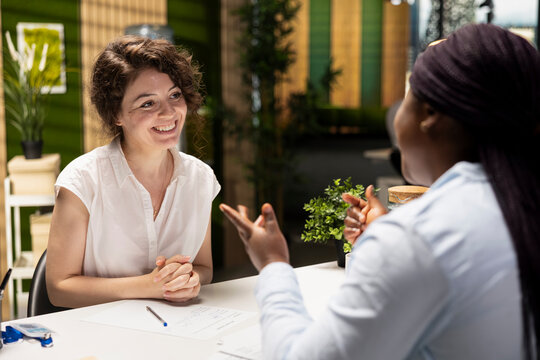 Black female applicant signing the new employment contract during job interview, being accepted on the department team by the HR manager. Signature for paperwork agreement. New beginning.