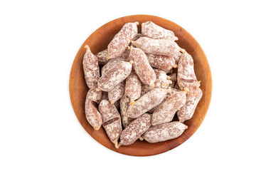 Small smoked Chicken sausages in wooden bowl isolated on white. top view, close up