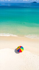 Obraz premium Colorful umbrella on a pristine beach