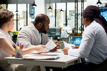 Recruiters reviewing feedback from artificial intelligence platform, using automation and deep...