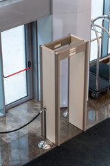 Automatic doors at a modern building entrance with a security metal detector scanner