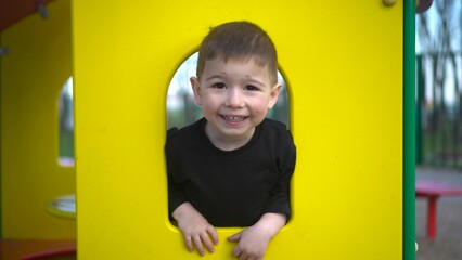 A child joyfully playing in a colorful playhouse, filled with joy and creativity