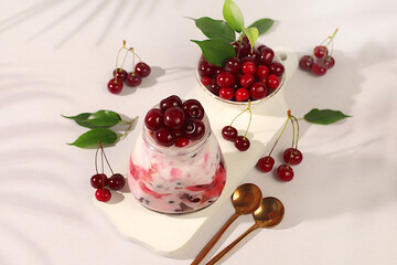 Cherry yogurt with berries in a glass on an elegant table, fruit salad, detox diet and natural...