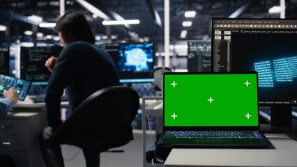 Close up of mockup laptop in server room where worker uses AI to review diagnostics. Admin in data center analyzing performance data using artificial intelligence on isolated screen notebook, camera A