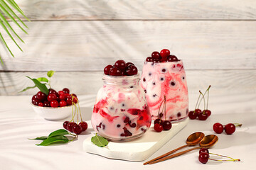 Cherry yogurt with berries in a glass on an elegant table, fruit salad, detox diet and natural...
