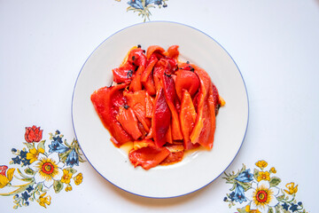 white plate with red pepper slices
