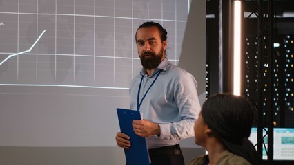 Group of business associates preparing their forecast pitch for a discussion with investors,...
