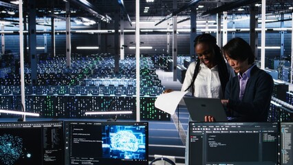 Data center engineers managing AI systems for uptime and efficiency, looking over paperwork files....