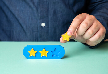The man holds the third star rating. Award the maximum score. Reviews and feedbacks, reflecting...