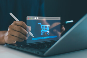 Hand of man using digital pen interacting with virtual shopping cart icon on laptop screen, representing modern e-commerce, online shopping technology and digital retail platforms. Online payment.