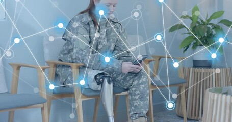Seated soldier wearing prosthetic leg tapping smartphone activating overlay analyzing health data - Powered by Adobe