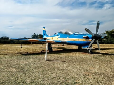 Blue airplane in open field