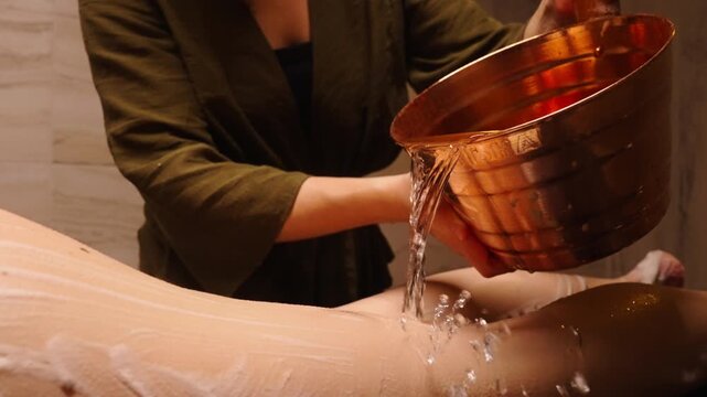 Washing Body In Hammam Or Steam Bath, Closeup View Of Metal Bucket With Cold Water And Female Legs