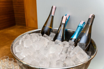Elegant banquet setup with wine and champagne bottles chilling in a large ice bowl