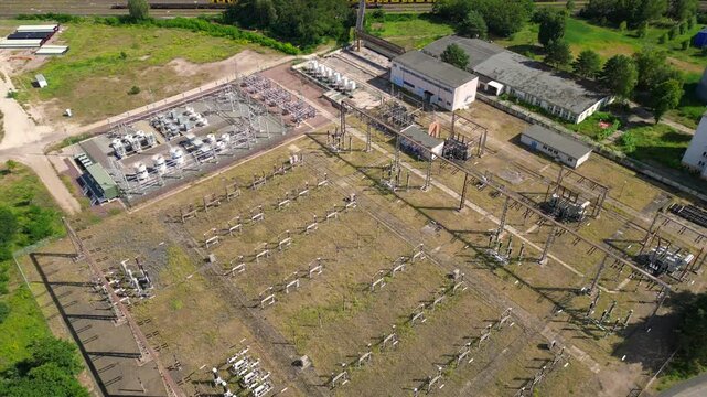 substation distributing electricity at forest. Magic aerial view flight drone