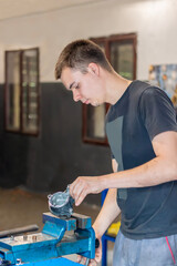 The technician repairs the starter (anlasser) by hand. Car repairs, workshop repair vehicles...