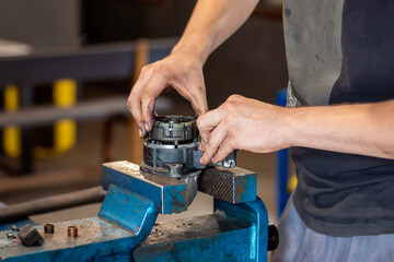 The technician repairs the starter (anlasser) by hand. Car repairs, workshop repair vehicles...