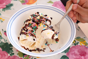 Scooping Vanilla Ice Cream with Chocolate and Sprinkles