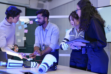 A multidisciplinary team in an agile R&D session for a bionic limb. They assemble prototypes while...