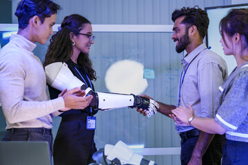 A female developer with a bionic arm shakes hands with a colleague. A powerful concept for human-computer interface, corporate inclusion, and assistive technology in the future workplace.