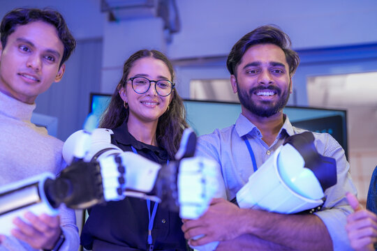 A diverse team of young engineers proudly presents their robotic prosthetic arm. A concept for innovation in robotics, bionics, assistive technology, and collaborative teamwork in STEM. - Powered by Adobe